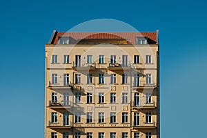 Residential building facade, house isolated on blue sky