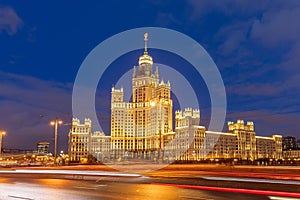 Residential building on Kotelnicheskaya embankment in Moscow against the dark blue evening sky. Stalin skyscraper at