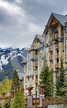 Residential building on snow-capped mountains background