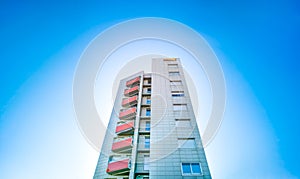 Residential building under blue sky with white circle