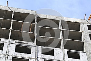 Residential building under construction. Reinforced concrete structure on a spring day. Real estate construction, apartments