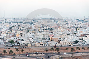 Residential buildings, city buildings, streets and roundabout in Sur, Oman