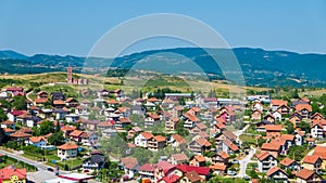 Residential buildings and houses in charming hilly landscape, aerial view