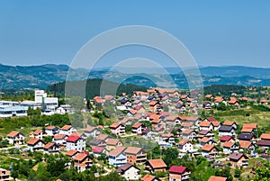 Residential buildings and houses in charming hilly landscape, aerial view