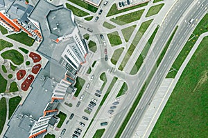 Residential buildings with a playground in a courtyard and parking lot. aerial view
