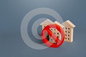 Residential buildings and red prohibition symbol No. Restrictions ban on construction. Inaccessible expensive housing. Restriction