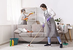 Residential Cleaning Services. Couple Of Skilled Housekeepers Tidying Up Apartment