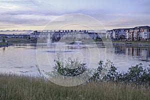 Residential complex apartments with lake and fountains in foreground