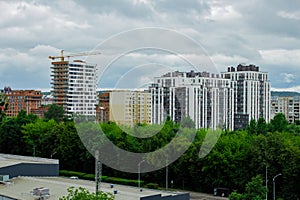 Residential complex under construction with big crane on site. New aparments buildings under construction.