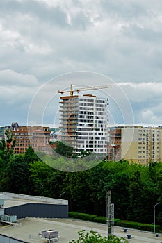 Residential complex under construction with big crane on site. New aparments buildings under construction.