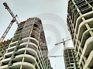 Residential complex under construction with cranes in the city 2030