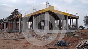 Residential construction site concrete foundation, wooden beams,, incomplete walls amidst building materials, home