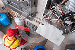 Residential Heating Systems Technician Performing Maintenance