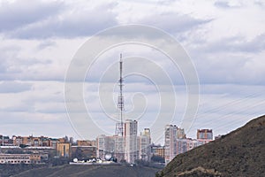 Residential high-rise buildings on top of a mountain across the river.