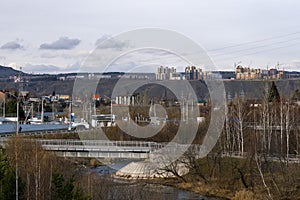 Residential high-rise buildings on top of a mountain across the river.