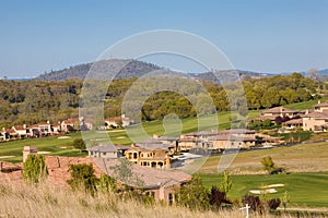 Residential homes on a hilly golf course photo