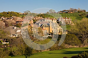 Residential homes on a hilly golf course photo