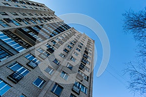 Residential house on blue sky background. Block of flats from soviet times