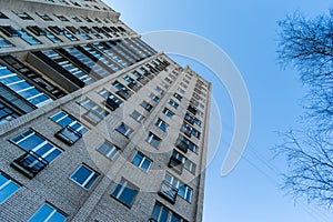 Residential house on blue sky background. Block of flats from soviet times