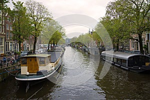 Residential house-boats on the Princes canal on a cloudy September morning. Amsterdam