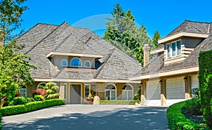 Residential house with massive roofs on blue sky background