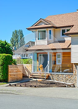 Residential house with porch and concrete pathway over the front yard.