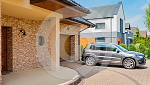 Residential house with silver suv car parked on driveway in front photo