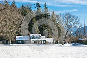 Residential house in snow on a sunny day