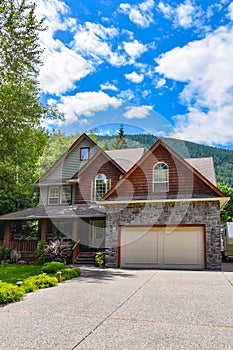 Residential house with wide concrete driveway and wide garage door