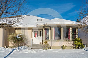 Residential house on winter sunny day decorated for Christmas celebration