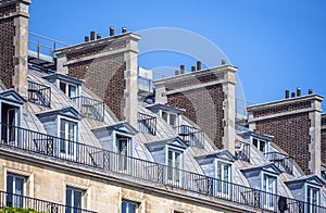 Residential lofts with balconies and large brick chimneys in Paris
