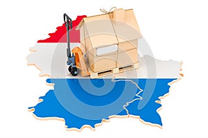 Residential moving service in Luxembourg, concept. Hydraulic hand pallet truck with cardboard house parcel on Luxembourgish map,