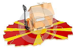 Residential moving service in Macedonia, concept. Hydraulic hand pallet truck with cardboard house parcel on Macedonian map, 3D