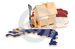 Residential moving service in the Netherlands, concept. Hydraulic hand pallet truck with cardboard house parcel on the Netherlands