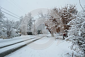 Residential neighborhood city street in severe snowstorm slant view