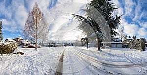 Residential Neighborhood in the Suburbs with White Snow covered road