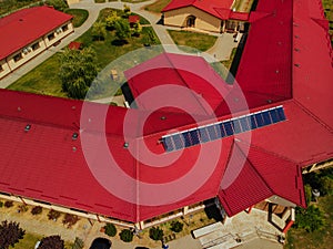 Residential red roof tile with with solar panels
