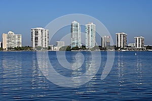 Residential towers reflected in calm water of Biscayne Bay in Miami, Florida.