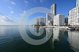 Residential towers reflected in calm water of Biscayne Bay in Miami, Florida.