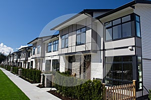 Residential townhouses on blue sky background on sunny day. External facade of a row of colorful modern urban townhouses.brand new