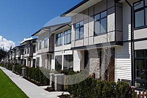 Residential townhouses on blue sky background on sunny day. External facade of a row of colorful modern urban townhouses.brand new