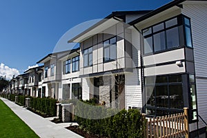 Residential townhouses on blue sky background on sunny day. External facade of a row of colorful modern urban townhouses.brand new