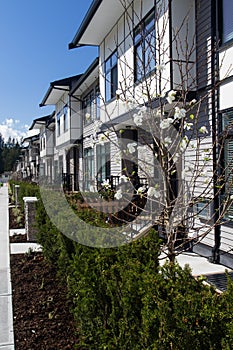 Residential townhouses on blue sky background on sunny day. External facade of a row of colorful modern urban townhouses.brand new