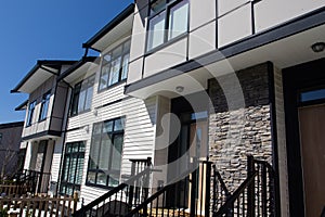 Residential townhouses on blue sky background on sunny day. External facade of a row of colorful modern urban townhouses.brand new