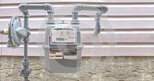 Residential urban natural gas meter measuring gas consumption, outside house gas meter