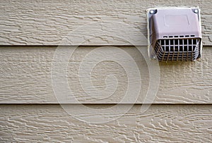 Residential vent pest screen on the side of a house