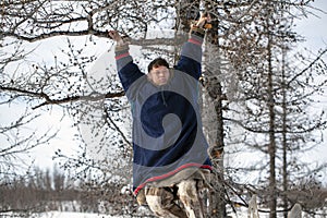 Residents of the far north,  the pasture of Nenets people, the dwelling of the peoples of the north of Yamal,Young hunter hanging