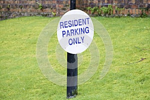 Residents parking only sign on green grass private garden