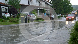 Residents of terraced house in the suburbs go out for a walk down flooded street