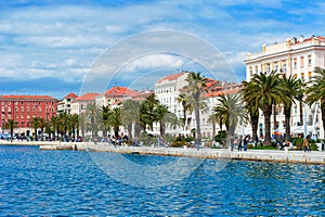 Residents and tourists walking along the shore in Split